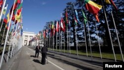 FILE - Television journalist reports in Flags Alley outside the United Nations, Geneva.