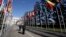 FILE - Television journalist reports in Flags Alley outside the United Nations, Geneva.