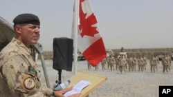 Brig.-Gen Dean Milner, Commander of Canadian forces in Afghanistan, speaks during a ceremony marking the Canadian handover of forward fire base Masum Ghar to US forces in Panjwaii district in Kandahar province, southern Afghanistan, July 5, 2011