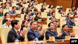 Vietnam's President Luong Cuong, Vietnam's communist party general secretary To Lam, Vietnam's PM Pham Minh Chinh and others attend the National Assembly's extraordinary session opening in Hanoi, Feb. 12, 2025. 