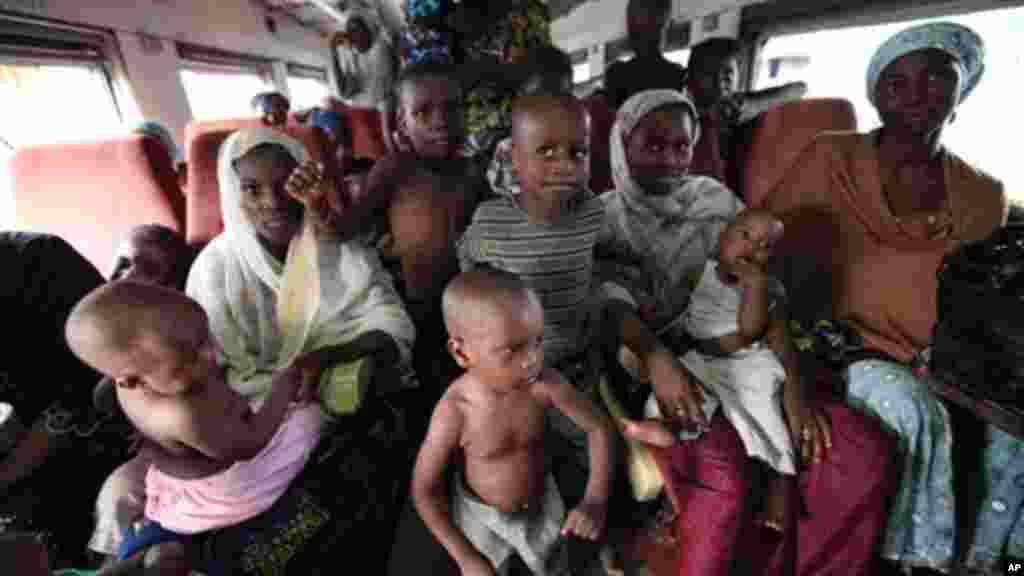 Families with children ride aboard an Ooni of Ife train to Kano, Nigeria.