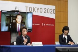 Seiko Hashimoto, front left, president of the Tokyo Organizing Committee of the Olympic and Paralympic Games (Tokyo 2020), speaks as Andrew Parsons, back left, president of the International Paralympic Committee, and Tamayo Marukawa, minister for…