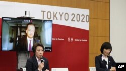 Officials of the Tokyo Olympics, Seiko Hashimoto, front left, Andrew Parsons, back left and Tamayo Marukawa at a meeting in Tokyo, March 11, 2021. Olympics Minister Marukawa said the vaccines have not been approved for use in Japan.