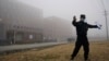 FILE - A security person moves journalists away from the Wuhan Institute of Virology after a World Health Organization team arrived for a field visit in Wuhan in China's Hubei province, Feb. 3, 2021. 