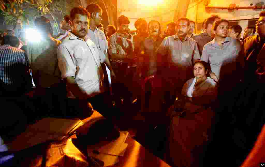 Chief Minister of West Bengal state Mamata Banerjee sits outside a morgue where bodies of victims of a fire are kept. (AP/Anupam Nath)