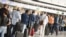 FILE - Air travelers stand in a queue in Terminal 1 of Frankfurt Airport, Germany, in front of a check-in counter, June 15, 2020.