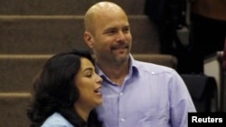 Gerardo Hernandez, one of so-called "Cuban Five," hugs his wife Adriana Perez during the National Assembly in Havana, Dec. 20, 2014.