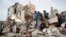 People inspect the rubble of houses destroyed by Saudi-led airstrikes in Sanaa, Yemen, Friday, Aug. 25, 2017. Airstrikes by a Saudi-led coalition targeted Yemen's capital early on Friday, hitting at least three houses in Sanaa and killing at least 14 civi