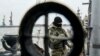 FILE - A Ukrainian serviceman stands on board a coast guard ship in the Sea of Azov port of Mariupol, eastern Ukraine, Dec. 3, 2018.