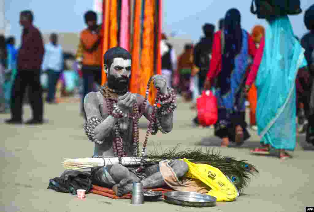 An Indian Hindu holy man sits on the banks of Sangam -- the meeting of the Ganges, Yamuna and mythical Saraswati rivers -- during the Kumbh Mela festival in Allahabad.