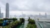 In this picture taken on April 9, 2021, Rooftop Republic urban farmers harvest vegetables grown on a rooftop farm at the top of the 150-metre tall Bank of America tower in Hong Kong