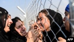 FILE - Newly displaced Iraqi's who fled from the city of Mosul, Iraq's last major Islamic State (IS) group stronghold, are reunited with their relatives who came two years ago to the refugee camp in the Khazer area.