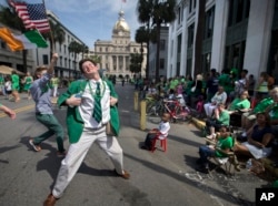 In this March 17, 2015 file photo Lamar Lester III dances while marching with the Doherty Clan during the 191st St. Patrick's Day parade in Savannah, Ga