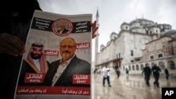 Un hombre muestra un cartel con imágenes del príncipe saudí Mohammed bin Salman y del periodista Jamal Khashoggi, describiendo al príncipe como 'asesino' y a Khashoggi como 'martir' durante oraciones fúnebres por la muerte del periodista en Estambul, Turquía, el 16 de noviembre