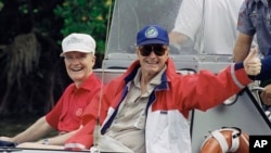 FILE - U.S. President George H. Bush gives the thumbs up as he returns from fishing in Charlotte Harbour with national security adviser Brent Scowcroft, while vacationing in Boca Grande, Florida, Nov. 12, 1992.