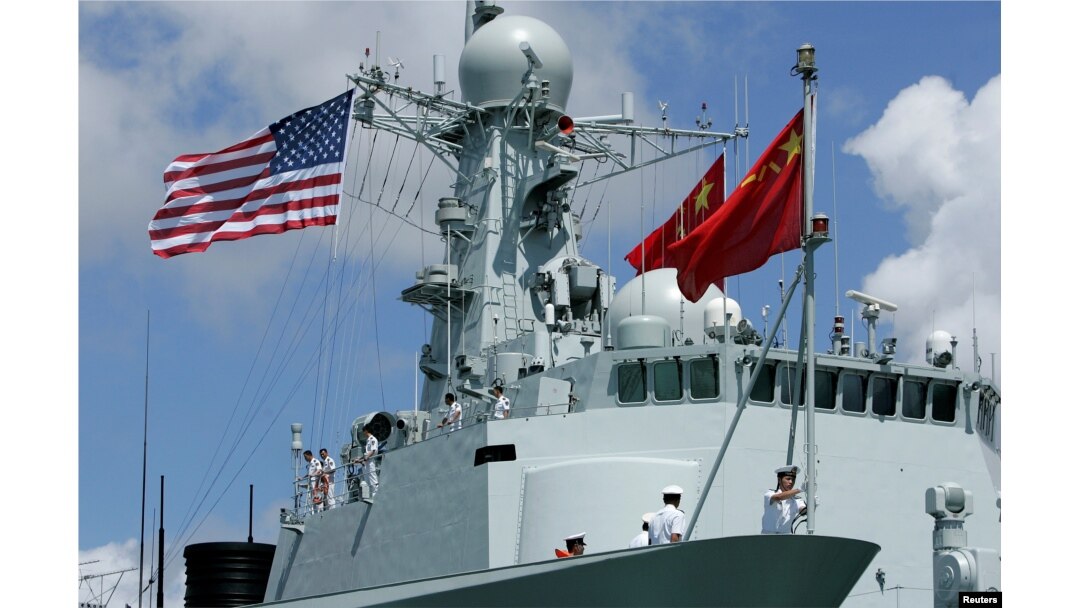 FILE - A sailor in China's People's Liberation Army Navy hoists the Chinese flag after arriving at the Joint Base Pearl Harbor Hickam to participate in the multinational military exercise RIMPAC in Honolulu, Hawaii, June 29, 2016.