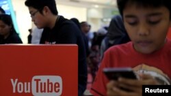 FILE - People attend the YouTube Fanfest in Jakarta, Indonesia, Oct. 23, 2016. 