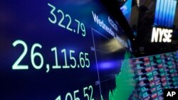 A screen above the trading floor of the New York Stock Exchange shows the closing number of the Dow Jones industrial average, Jan. 17, 2018.