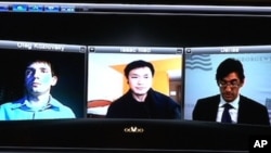 Oleg Kozlovsky, Issac Mao, Ernesto Hernandez Busto use the Skype technology to participate in the recent conference on the Internet and dissidents