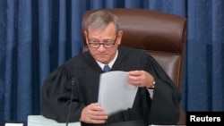 FILE: Chief Justice of the United States John Roberts presides during opening arguments in the U.S. Senate impeachment trial of U.S. President Donald Trump in this frame grab from video shot in the U.S. Senate Chamber at the U.S. Capitol in Washington, U.S., January 21, 2020.