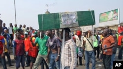 A man carries a coffin as protesters march through a road on the third day of a protest against a removal of fuel subsidies in Nigeria's commercial capital Lagos, January 11, 2012.