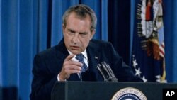FILE - President Richard Nixon gestures sternly during a press conference in Washington in 1973.