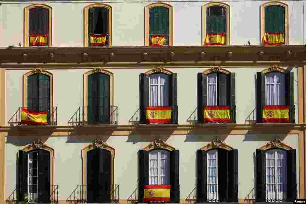 Spanish flags are seen on balconies in Malaga, Spain. The country is seeing displays of unity as&nbsp; Catalonia&rsquo;s separatist leaders are threatening to issue a declaration of independence on the back of last Sunday&rsquo;s unauthorized plebiscite.