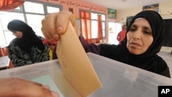 A Moroccan post her ballot at a voting station in Sale, near Rabat, July 1, 2011