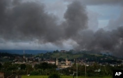 Black smoke from continuing military air strikes rises above a mosque in Marawi city, southern Philippines, June 9, 2017.