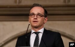 FILE - German Foreign Minister Heiko Maas addresses the media during a press conference in Oxford, England, April 12, 2018.