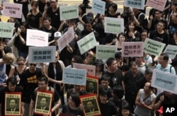 FILE - Hundreds of Hong Kong journalists, lawmakers and residents march to China's liaison office in Hong Kong, Sept. 13, 2009.