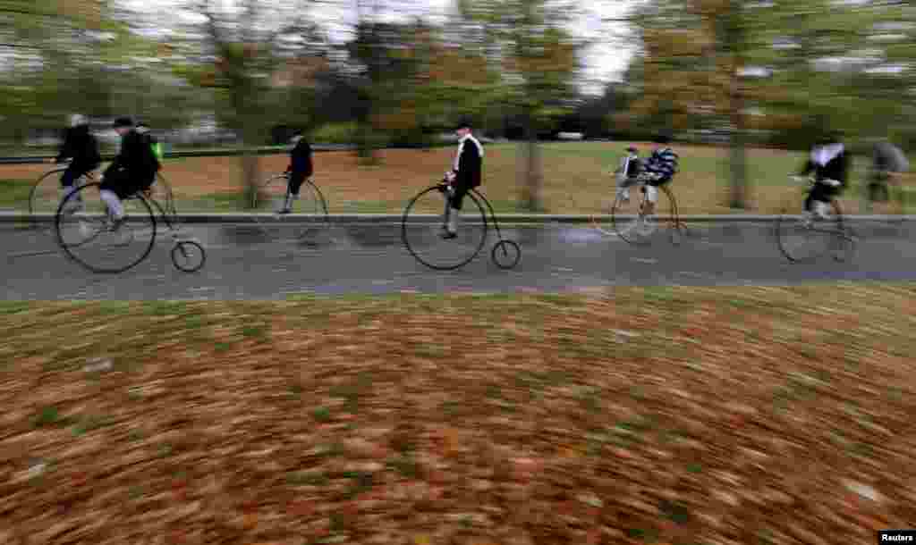 Participants wearing historical costumes ride their high-wheel bicycles during the annual penny farthing race in Prague, Czech Republic, Nov. 2, 2019.