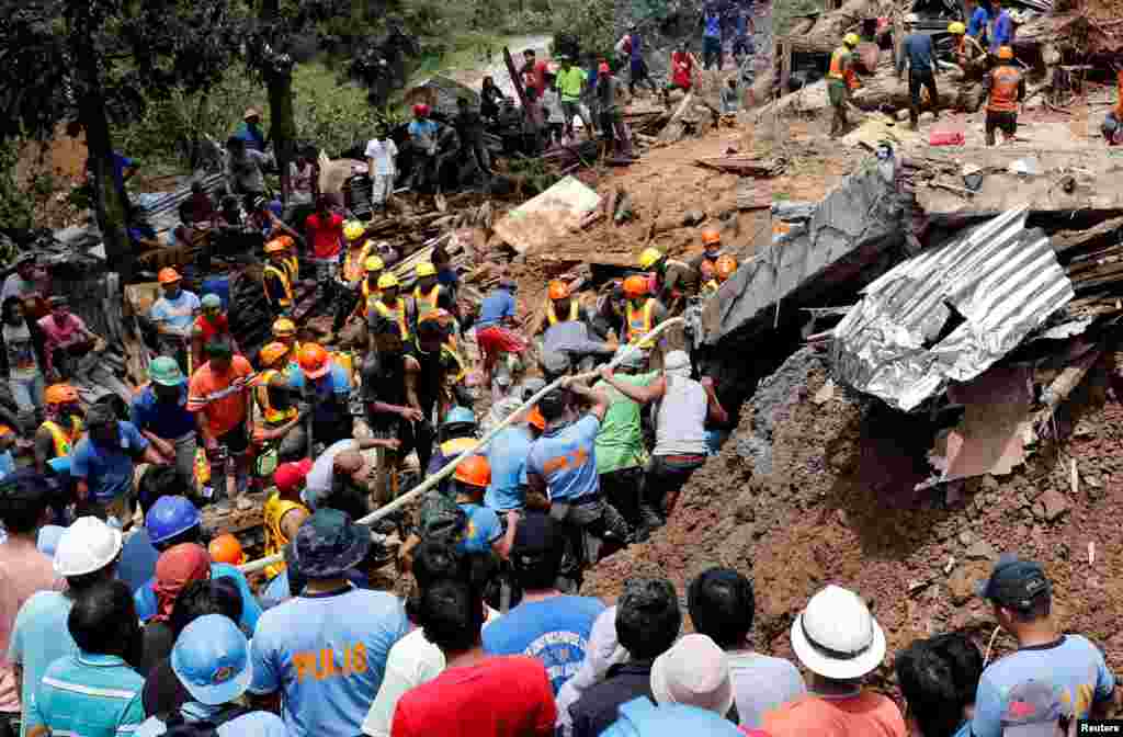Rescuers search for people trapped in a landslide caused by Typhoon Mangkhut at a small-scale mining camp in Itogon, Benguet, in the Philippines.