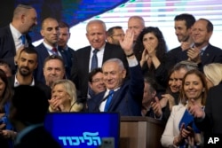 Israel's Prime Minister Benjamin Netanyahu waves to his supporters after polls for Israel's general elections closed in Tel Aviv, Israel, April 10, 2019.