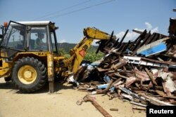 Theodoros Karagiannis' fishing boat, "Agios Theodoros" is destroyed in the port town of Stavros, Greece, June 13, 2018.