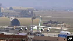 An Iranian airplane, which officials said was forced to land in southeast Turkey on Tuesday on suspicion that it may have been carrying arms to Syria, sits at the tarmac at Diyarbakir airport, March 16, 2011