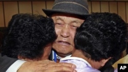 FILE - South Korean Lee Pung-no, center, weeps as he hugs with his North Korean daughters during the Separated Family Reunion Meeting at Diamond Mountain in North Korea.
