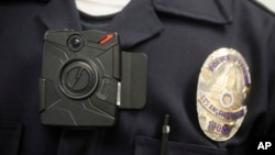 FILE - This 2014 photo shows a Los Angeles Police officer wearing an on-body cameras during a demonstration for media in Los Angeles.
