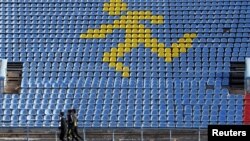 Sportsmen train at a local stadium in the southern city of Stavropol, Russia, Nov. 10, 2015.