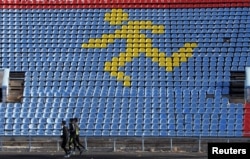 FILE - Athletes train at a local stadium in the southern city of Stavropol, Russia, Nov. 10, 2015.