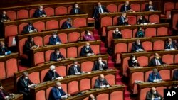 Senators, most wearing face masks, listen as Italian premier Giuseppe Conte informs them on coronavirus situation, in Rome, March 26, 2020. 