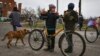 People carry food after collecting at a humanitarian aid point in the village of Drobyshava, Donetsk region, Ukraine, on November 18, 2022. 