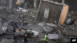 Rescuers check a building hit by an Israeli airstrike in Chiyah, a southern suburb of Beirut, Lebanon, on Nov. 22, 2024.