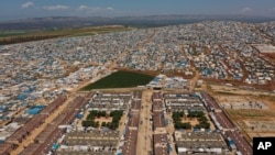 FILE - A refugee camp is seen on the Syrian side of the border with Turkey, near Atma, April 19, 2020. After nearly a decade of war, the country is crumbling under the weight of sanctions, government corruption, a pandemic and an economic slide.