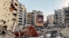 A portrait of slain Hezbollah leader Hassan Nasrallah sits amids debris at Beirut's southern suburb Rouweiss neighbourhood on October 10, 2024, following overnight Israeli strikes.