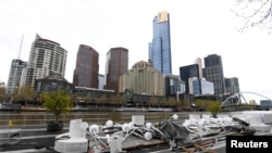 Parts of a decommissioned floating bar and restaurant are seen along the Yarra River as the city operates under lockdown, in Melbourne, Australia, Sept. 9, 2020. (AAP Image/James Ross via Reuters)