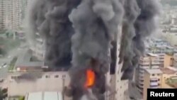 Smoke billows at a shopping centre following fire in the city of Zigong, Sichuan province, China, in this still image obtained from social media video on July 17, 2024. 