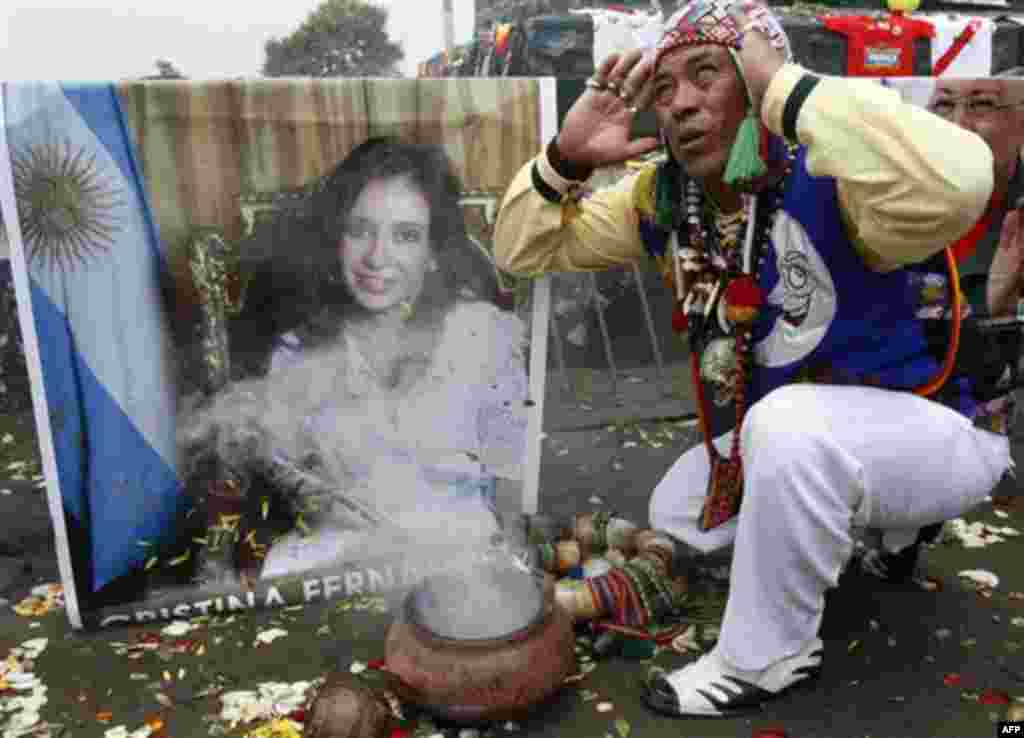 A shaman performs a ritual for good luck in 2012 as he prays in front of an image of Argentina's President Cristina Fernandez in Lima, Peru, Thursday Dec. 29, 2011. Fernandez was diagnosed with treatable thyroid cancer on Tuesday, and will undergo surgery