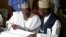 Independent National Electoral Commission chairman, Attahiru Jega, left, views election results at the coalition center in Abuja, Nigeria, Monday, March 30, 2015.