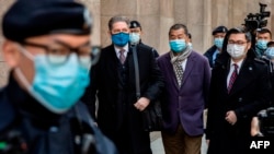 Hong Kong pro-democracy media tycoon Jimmy Lai (centre R) leaves the Court of Final Appeal in Hong Kong on December 31, 2020, during a break pending the court's decision on the prosecution's appeal against his bail after he was charged with the new…